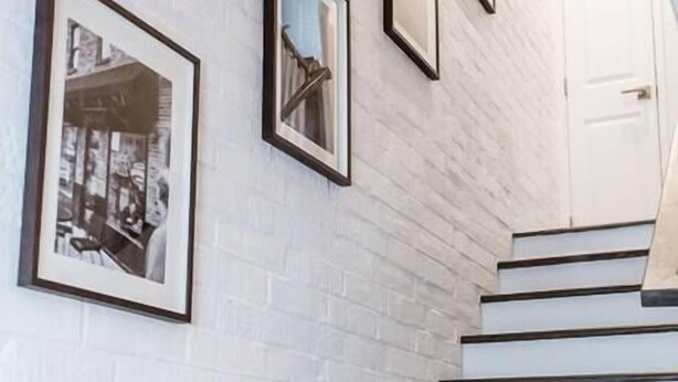 A staircase with white steps and dark risers, leading to a white door. - Renovated 2story (9C) OSU/Central ❤Near EVERYTHING (Columbus)