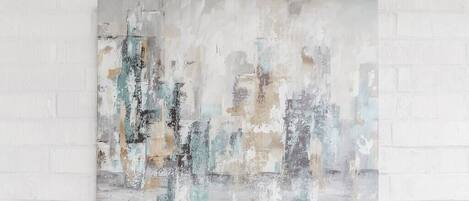 A painting on a white brick wall.