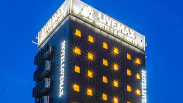 A multi-story hotel with a prominent 'LIVEMAX' sign, featuring a grid of uniformly lit windows and a modern architectural design. - HOTEL LiVEMAX OKAZAKI (Okazaki)