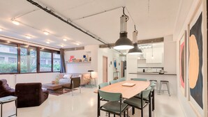 Ein moderner Wohnraum mit Essbereich, Küche und Sitzgelegenheit.