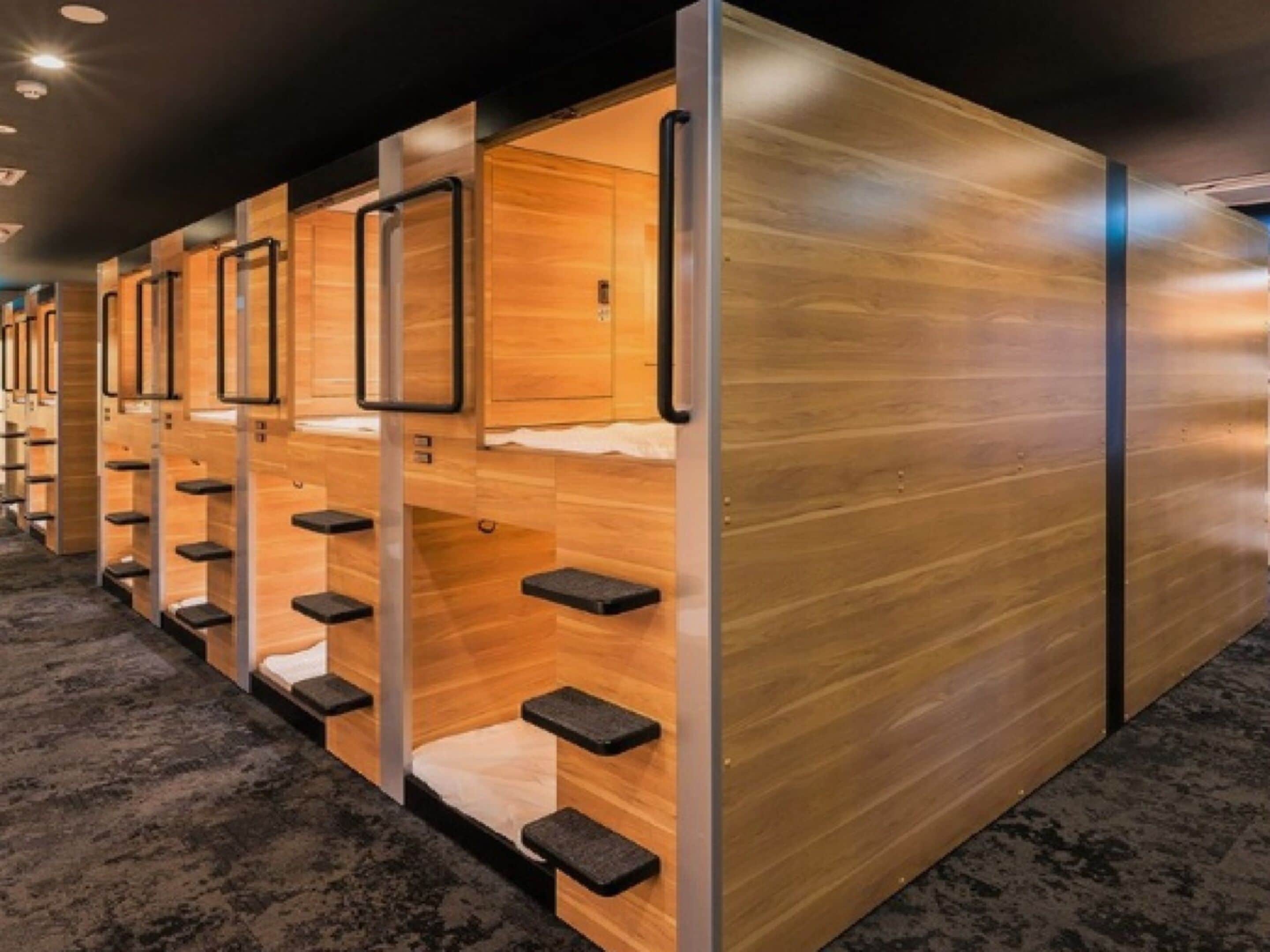 A row of bunk beds with built-in storage compartments and a wooden finish.