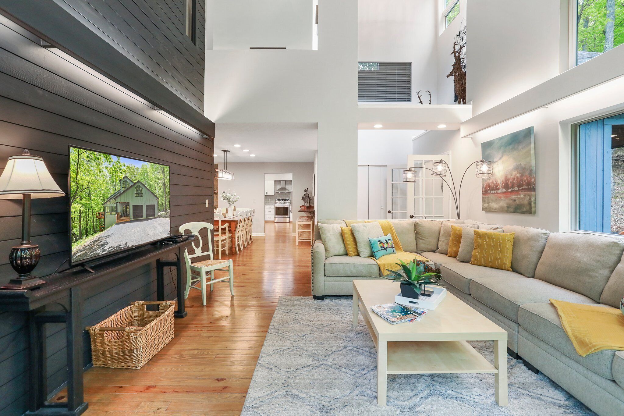 A spacious living room with a fireplace, a sofa, and a television.