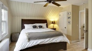 Cozy retreat with a single bed, bedside table, and ceiling fan.