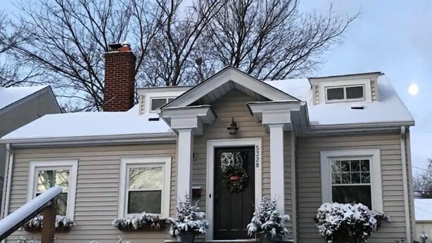 A two-story house with a front porch, a chimney, and a front door with a wreath. - Fulton Retreat - Downtown Minneapolis - 50th and France! (Minneapolis)