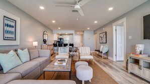 A spacious living room with a sofa, armchairs, a coffee table, and a dining area in the background. - Ramsgate 22 | Renovated Gulf-Front Escape (Panama City Beach)