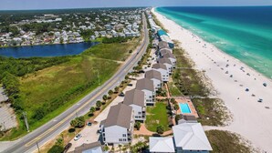 An aerial view of a coastal residential area with a beach, a road, and a lake. - Ramsgate 22 | Renovated Gulf-Front Escape (Panama City Beach)