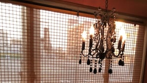 A dining area with a table set for two, a menu, chopsticks, a small bowl, and a teapot. - Good Bless Garden Sauna Stay (Yonago)