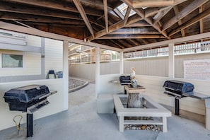 Enjoy al fresco dining in this outdoor space with barbecue grills and a small table.
