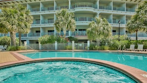 A hotel with a swimming pool, multiple balconies, and lush greenery. - Bikes and beach chairs included!30A-Studio between Rosemary and Alys Beach (Seacrest Beach)