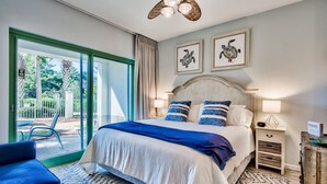 A bedroom with a large bed, a nightstand, a chair, and a view of the outdoors. - Bikes and beach chairs included!30A-Studio between Rosemary and Alys Beach (Seacrest Beach)
