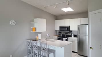 Fridge, coffee/tea maker, cookware/dishes/utensils
