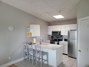 Fridge, coffee/tea maker, cookware/dishes/utensils