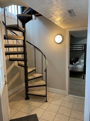 A spiral staircase with cushioned steps leading to a landing. - Bayview Condos #3, Ogallala Beach! Great Location! (Ogallala)
