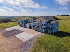 A residential building with a large driveway and a grassy area. - Bayview Condos #3, Ogallala Beach! Great Location! (Ogallala)