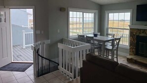 A spacious living area with a balcony, a dining table, and a fireplace. - Bayview Combo Condos 3 & 4, Ogallala Beach (Ogallala)