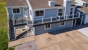 A two-story residential building with a covered outdoor area and a staircase leading to the upper level. - Bayview Combo Condos 3 & 4, Ogallala Beach (Ogallala)