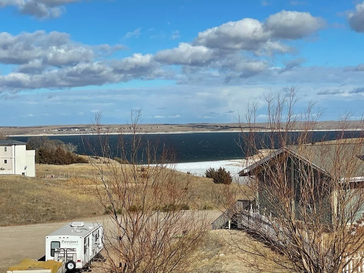 A view of a coastal area with a small building and a trailer.