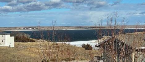 A view of a coastal area with a small building and a trailer.