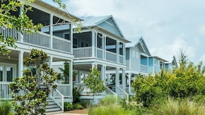 A two-story house with a balcony and a porch.