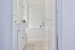 Bathtub, hair dryer, towels, soap