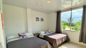 A room with two beds, a ceiling light, and a window with curtains. - 🏅 Mediterranean Beach Style Villa with Private Pool & Jacuzzi (Tocaima)