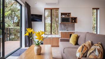 Deluxe Tree Lodge | Living area | LCD TV, heated floors