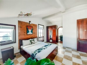 A bedroom with a bed, a wooden headboard, a window, a wardrobe, and a checkered floor. - Sun Villa (Nha Trang)