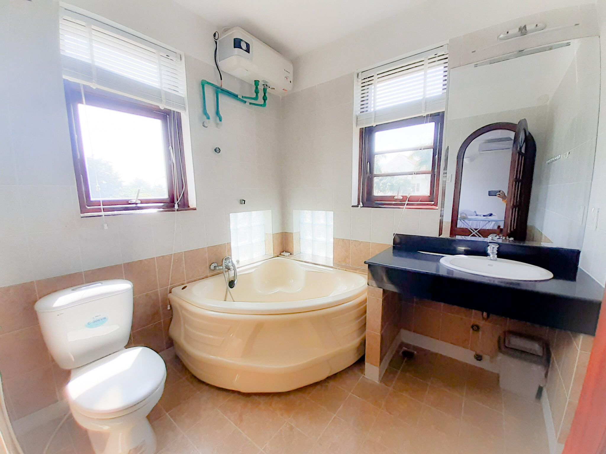 A bathroom with a toilet, a bathtub, and a sink.