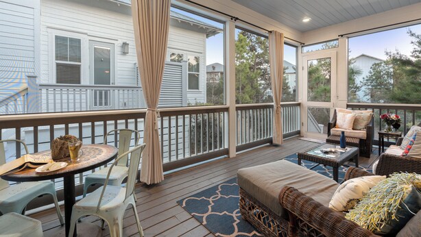 A covered outdoor deck with a table, chairs, and a sofa. - Three Times The Fun by AvantStay | Blue Mountain | Pool + Pet-Friendly (Santa Rosa Beach)