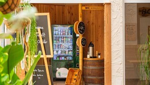 A cozy cafe with a wooden interior, a snack bar, and a coffee machine.