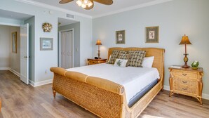 A spacious bedroom with a large bed, a ceiling fan, and a nightstand with a lamp. - Grand Surf 7W! PCB Most Prestigious Address. Huge Condo, Exceptional. (Panama City Beach)