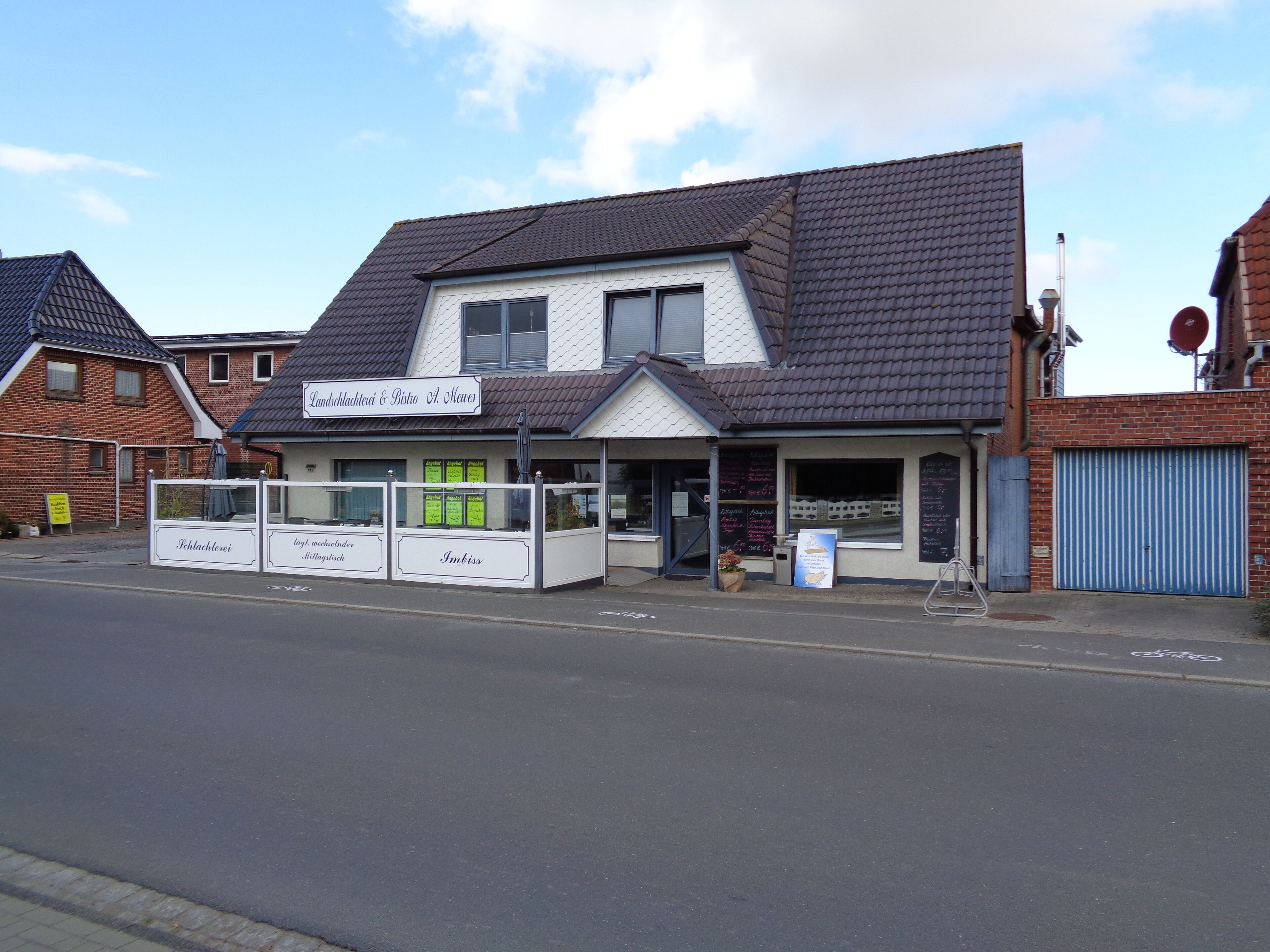 A two-story building with a sign reading "Landschlachterei & Bäcker A Meier" and a visible storefront.