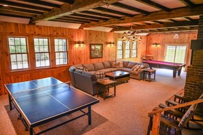 A wooden-paneled room with a ping pong table, a sofa, a pool table, and a staircase. - Mt. Snow townhouse with fireplace, 1 mile to the slopes with weekend shuttle! (Dover)