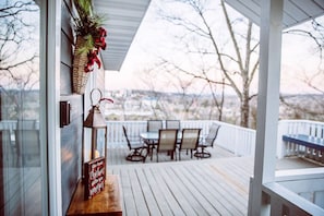 Enjoy a tranquil outdoor space with a deck, table, and chairs, offering a serene view of the surrounding landscape.