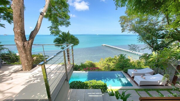 A pool area with a view of the ocean, a wooden deck, and lounge chairs. - The Headland Villa 2, stunning beachfront, Samui (Koh Samui)