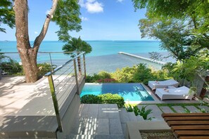 A pool area with a view of the ocean, a wooden deck, and lounge chairs. - The Headland Villa 2, stunning beachfront, Samui (Koh Samui)