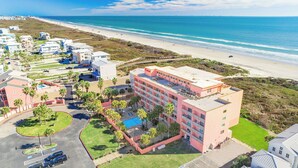 A hotel with a pool, located near a beach with a clear view of the ocean. - Beachfront Boutique Resort | Beachfront Bliss | Casa Condo 103 (Port Aransas)