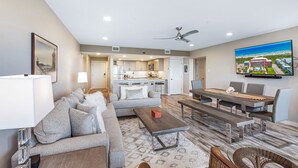 A modern living room with a sofa, coffee table, and dining area. - Beachfront Boutique Resort  |  Coastal Retreat  |  Casa Condo 203 (Port Aransas)