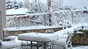 An outdoor patio area with a metal table and chairs covered in snow. - Alta/Snowbird Area Private Vacation Home, 9 miles to Resorts (Sandy)