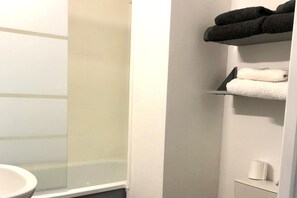 Bathtub, hair dryer, towels, soap