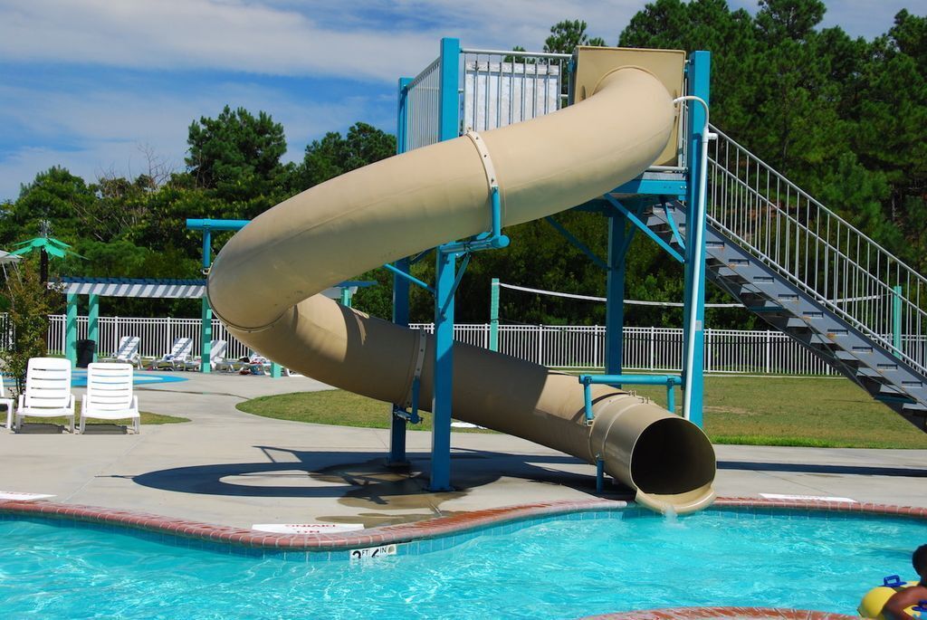A water slide structure with a pool at the base.