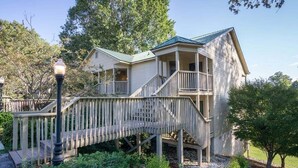 A two-story house with a porch and a wooden bridge leading to the entrance. - Apple Valley  63 at Rumbling Bald (Lake Lure)