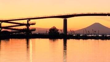 A bridge over water with a mountain in the background.