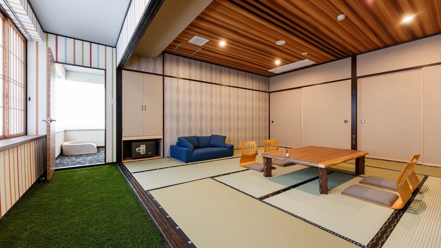 A tatami mat room with a wooden table, blue sofa, and tatami chairs.