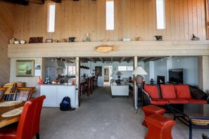 A spacious living area with a kitchen, dining area, and a loft with a fish decoration. - Whale Rock House Beach Front (2nd FL) - (STR#03-2662) (Dana Point)