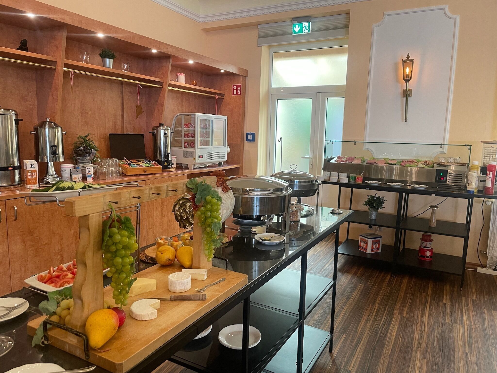 A well-equipped kitchen with various appliances, a buffet setup, and a variety of food items.