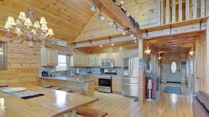 A spacious kitchen with wooden cabinets, a large island, and modern appliances.