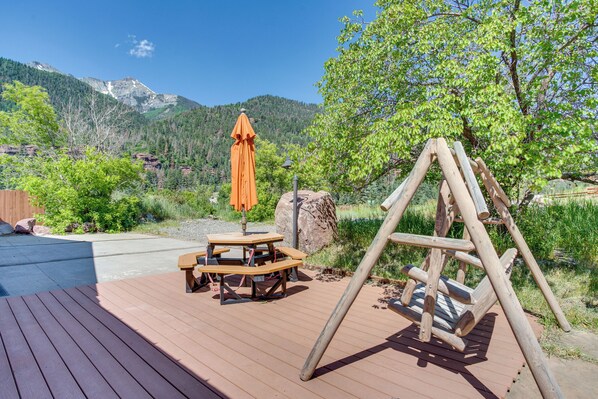 Relax on the deck surrounded by lush greenery and take in the breathtaking mountain views.
