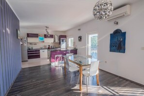 Enjoy meals in the kitchen and dining area, featuring a central island with a sink and oven.