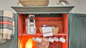 A kitchen area with a coffee machine, a salt lamp, and a decorative bowl. - Cozy & Quiet Studio w/ Porch, Near Scenic Railway! (Blue Ridge)
